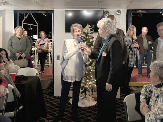 St. Cloud’s Betty Damke and Dirk Webb, the St. Cloud Chamber CEO, welcome members to the Merry Mingle, where best float and group winners from the St. Cloud Christmas Parade were announced. PHOTO/ST. CLOUD CHAMBER