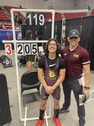 St. Cloud's Mikey Ziss, with Bulldogs lifting coach Cory Aun, setting a state snatch record at the 119-pound class, lifting 205 pounds. PHOTO/SDOC
