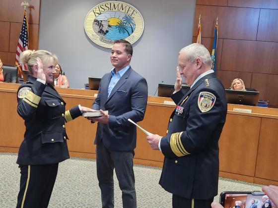 New Kissimmee Police Department Chief Betty Holland is officially sworn in at Tuesday's City Commission meeting by her predecessor, Jeff O'Dell. PHOTO/KEN JACKSON