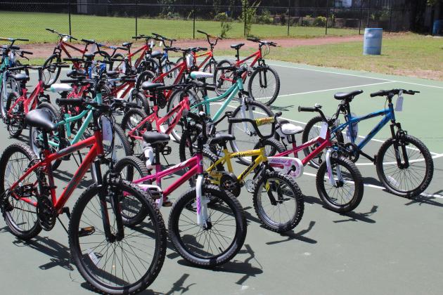 The bikes were a donation from Waste Management; city Parks & Recreation officials identified the recipients. PHOTO/KEN JACKSON