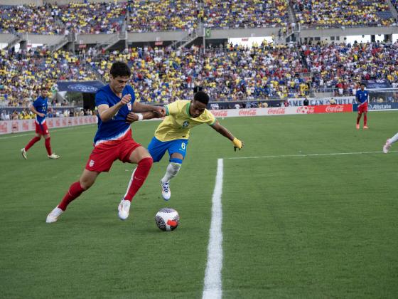 USA Gio Reyna tries to dribble past Brazilian defender Wendell in Wednesday's friendly match at Camping World Stadium. PHOTO/MARIO CASAMALHUAPA