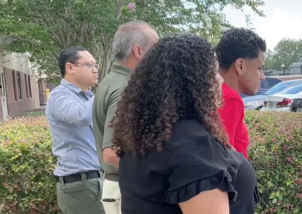 Jose Alvarado (in red shirt) was led away to the Osceola County Sheriff's Office Wednesday on seven counts related to having sex with a minor male. PHOTO/OSCEOLA COUNTY SHERIFF'S OFFICE